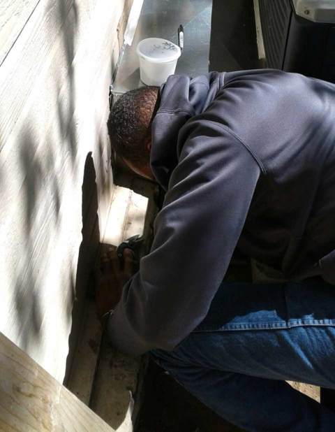 Owner Tyrone Nichols inspecting a customer's air conditioner