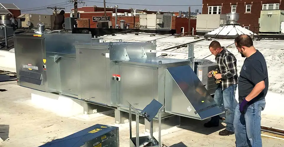 Nichols & Sons HVAC technicians installing a commercial AC unit in Tulsa, OK
